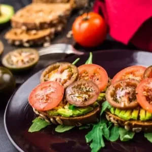 Vegan Sandwich with whole grain bread, avocado, and almond butter